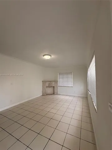 a view of an empty room and window