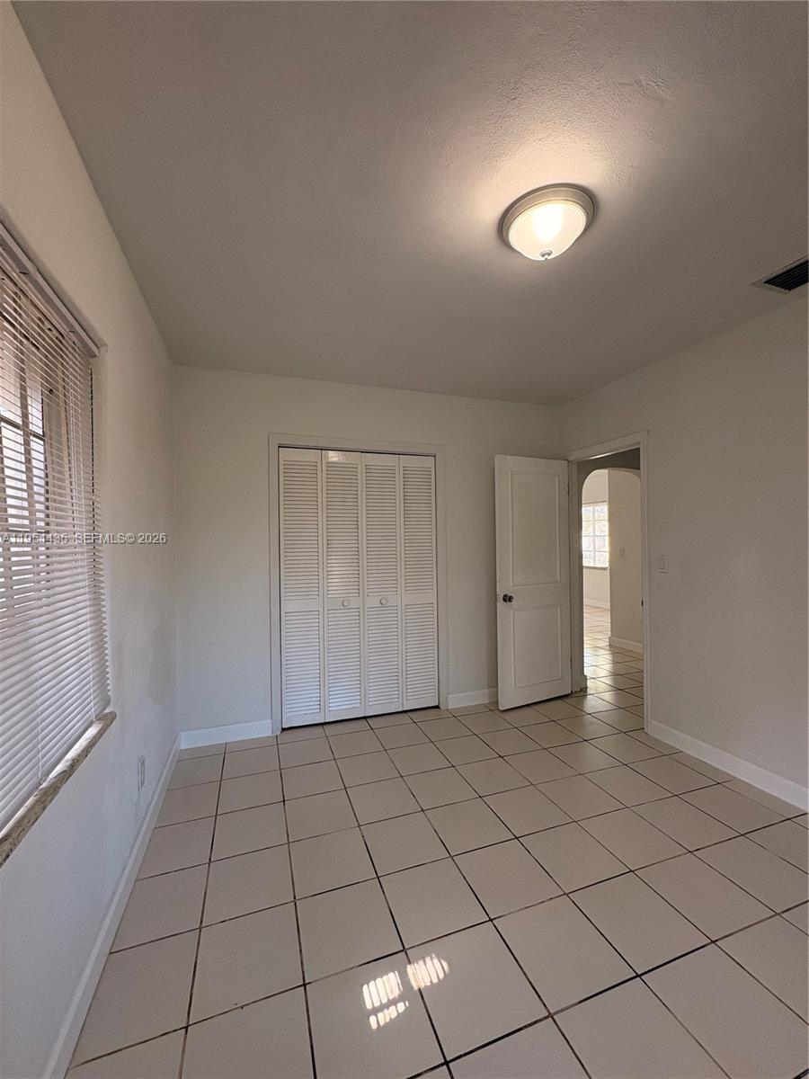 2390 Northwest 30th Street Miami, FL 33142 - Photo 9 of 11 a view of an empty room and window