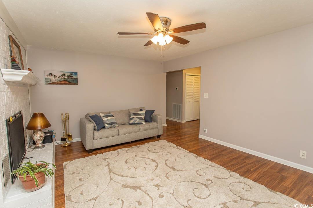 18 Pine Valley Lane Surfside Beach, SC 29575 - Photo 15 of 35 Living room with ceiling fan, wood finished floors, baseboards, and a fireplace