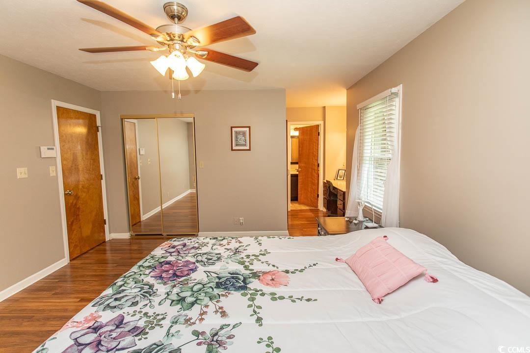 18 Pine Valley Lane Surfside Beach, SC 29575 - Photo 21 of 35 Bedroom featuring wood finished floors, baseboards, ceiling fan, and a closet