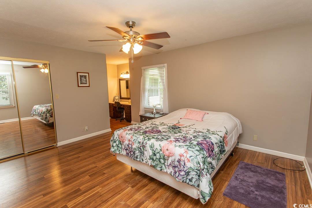 18 Pine Valley Lane Surfside Beach, SC 29575 - Photo 33 of 35 Bedroom featuring wood finished floors, baseboards, a closet, and a ceiling fan
