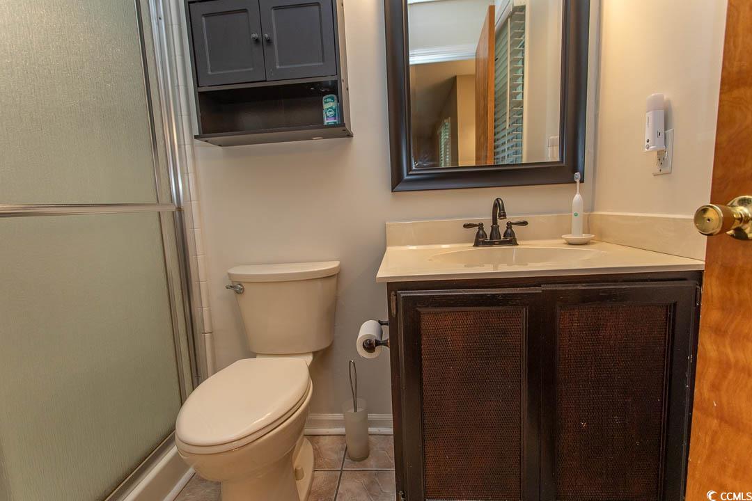18 Pine Valley Lane Surfside Beach, SC 29575 - Photo 35 of 35 Bathroom with vanity, a stall shower, toilet, tile patterned floors, and baseboards