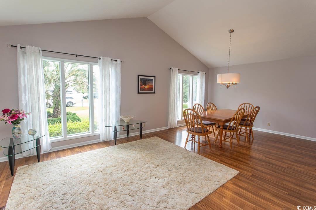 18 Pine Valley Lane Surfside Beach, SC 29575 - Photo 9 of 35 Dining area with high vaulted ceiling, a chandelier, dark wood-style flooring, and baseboards