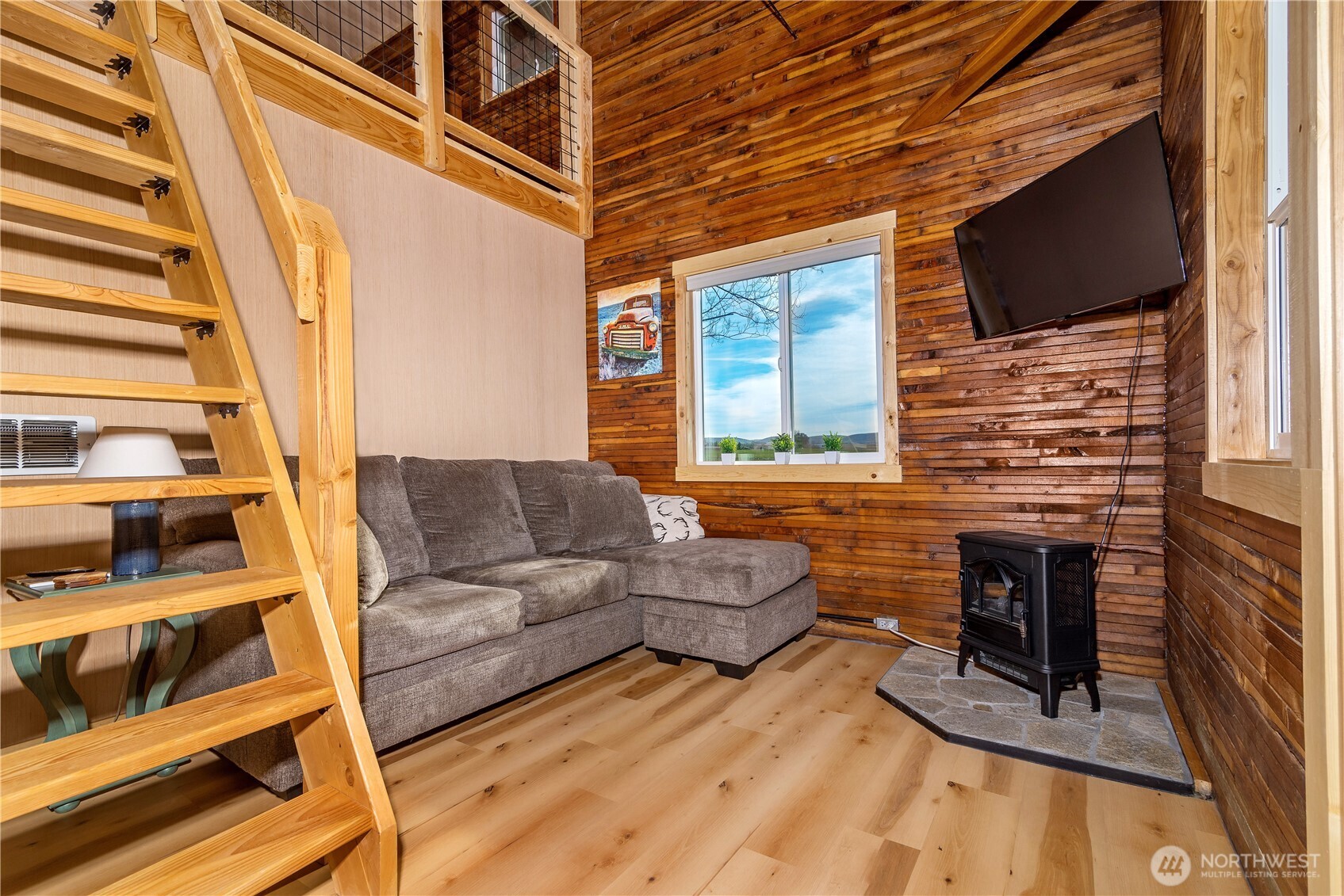 5920 4th Parallel Road Ellensburg, WA 98926 - Photo 9 of 30 a living room with furniture flat screen tv and a fireplace