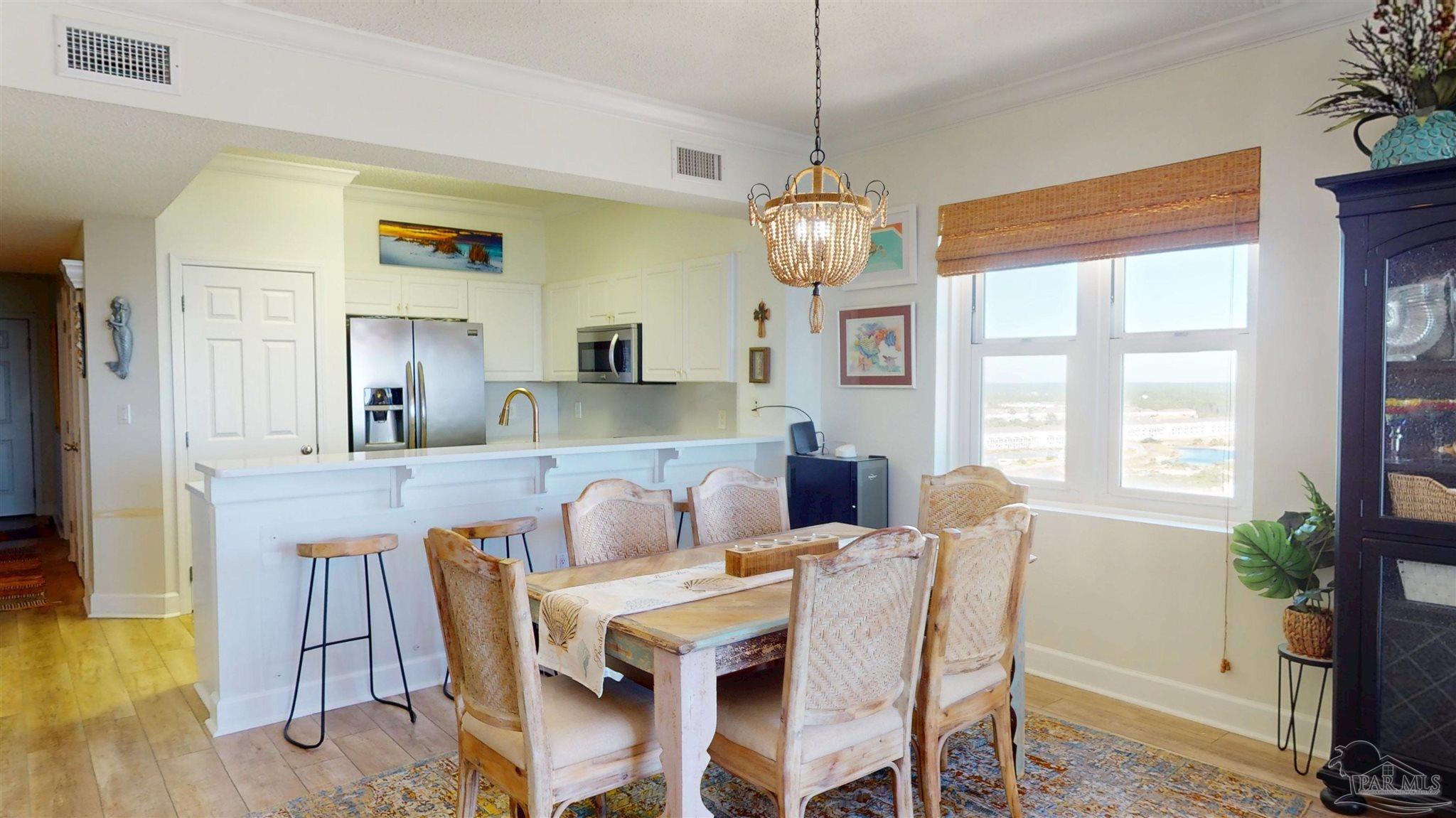 14511 Perdido Key Drive, Unit 1301 Perdido Key, FL 32507 - Photo 22 of 65 a view of a dining room with furniture window and wooden floor