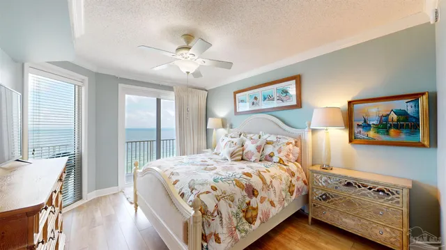 a bedroom with a large bed and a chandelier