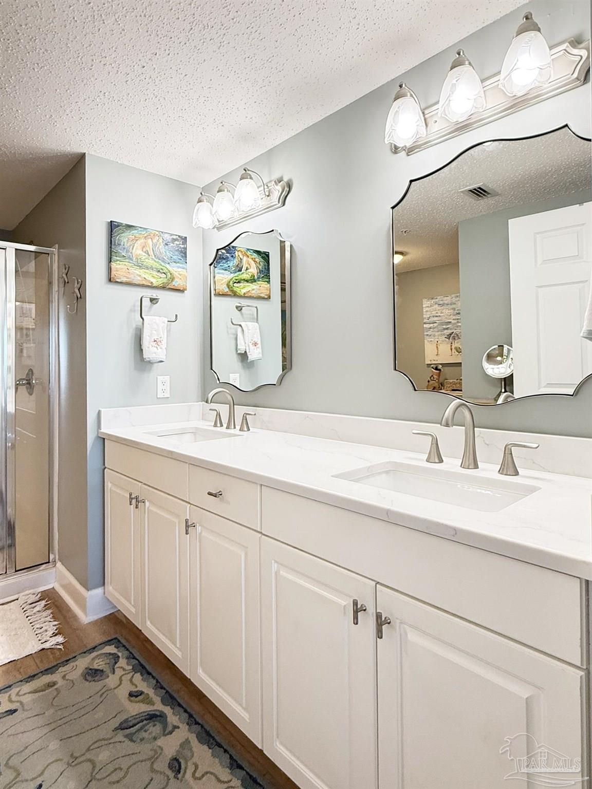 14511 Perdido Key Drive, Unit 1301 Perdido Key, FL 32507 - Photo 32 of 65 a bathroom with a double vanity sink and a mirror