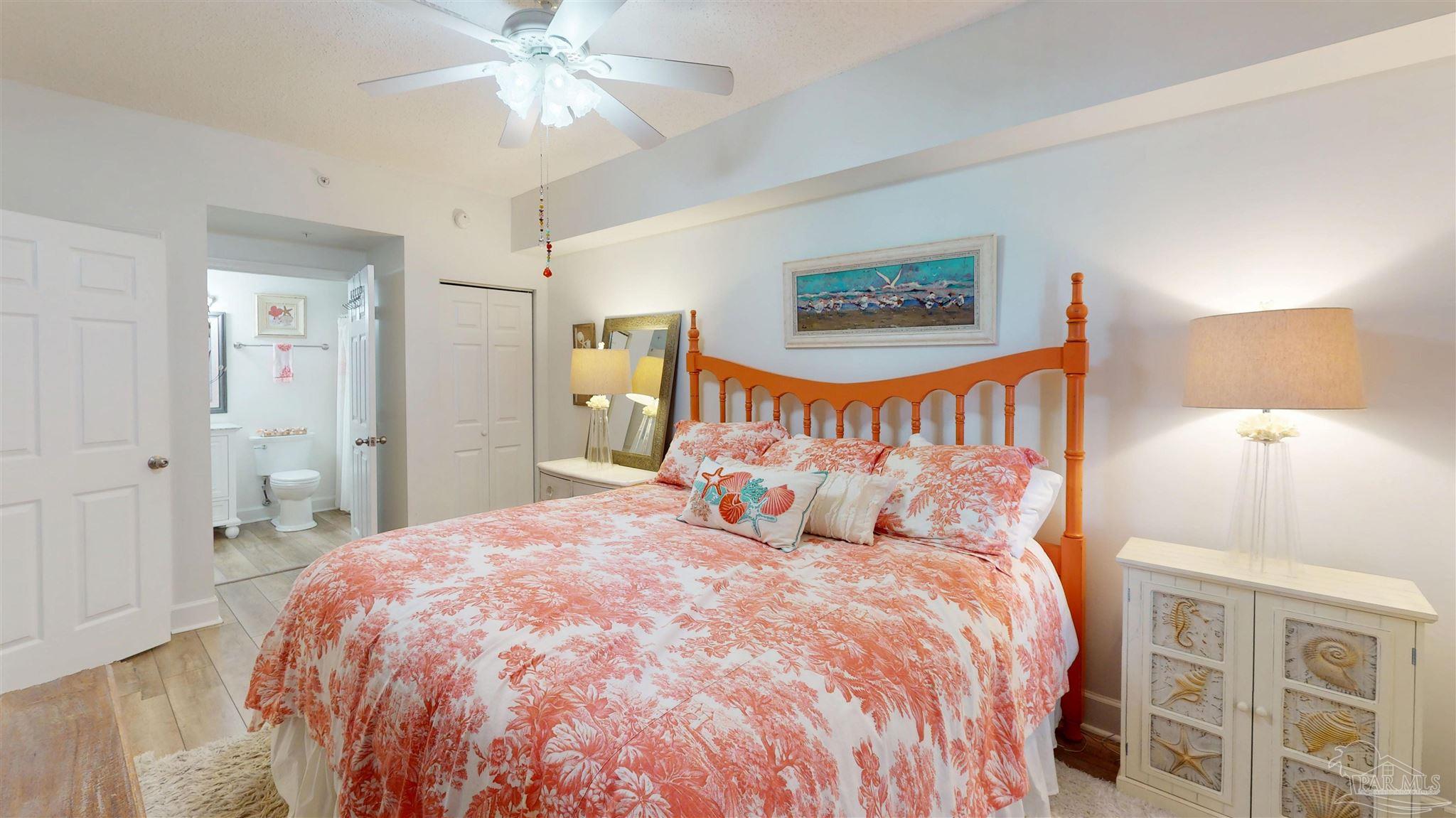 14511 Perdido Key Drive, Unit 1301 Perdido Key, FL 32507 - Photo 37 of 65 a bedroom with a large bed and a chandelier