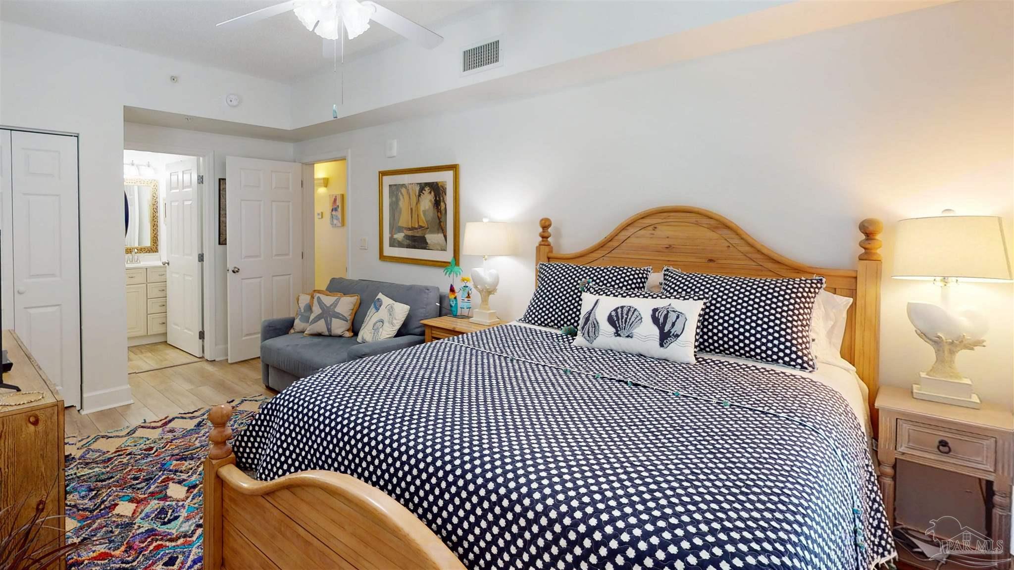 14511 Perdido Key Drive, Unit 1301 Perdido Key, FL 32507 - Photo 45 of 65 a bedroom with a bed and a lamp