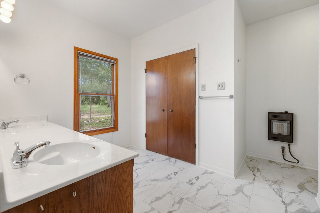 244 Woodway Elgin, TX 78621 - Photo 24 of 40 a bathroom with a sink and a mirror