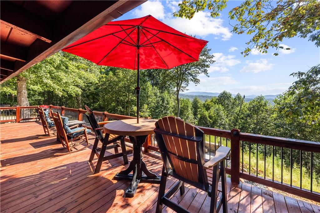832 Scenic Mountain View Road Blue Ridge, GA 30513 - Photo 42 of 56 a view of a balcony with furniture and wooden floor