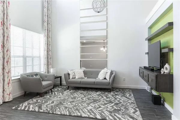 a living room with furniture and wooden floor