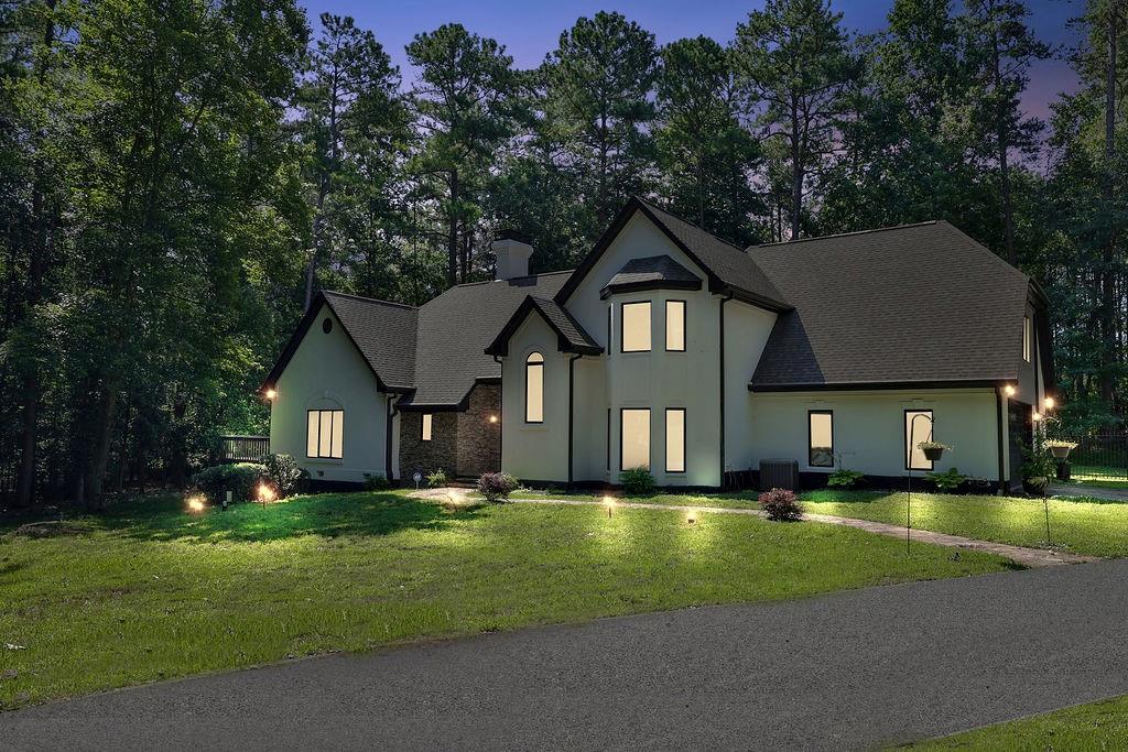 a front view of a house with yard and green space