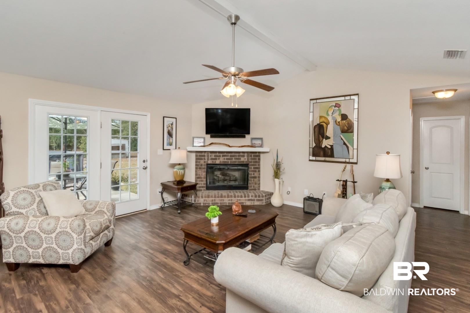 11528 Mocking Bird Lane Fairhope, AL 36532 - Photo 24 of 45 Living room featuring dark wood-style floors, ceiling fan, beamed ceiling, and a brick fireplace