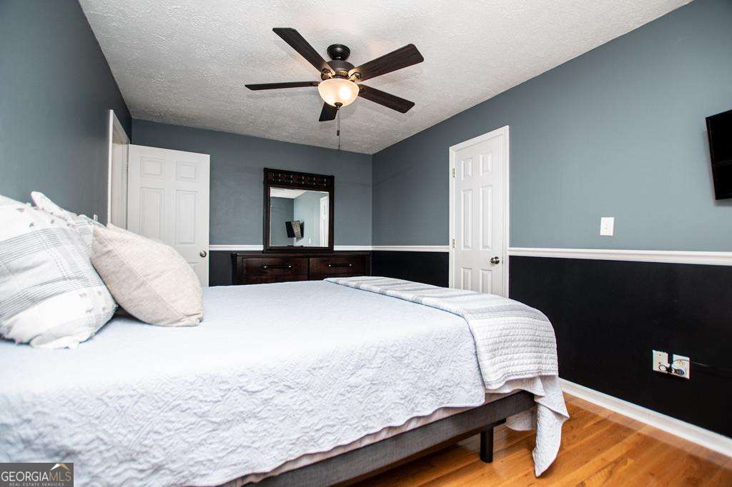 2 Pine Hill Drive Ranburne, AL 36273 - Photo 49 of 91 a bedroom with a large bed and a ceiling fan