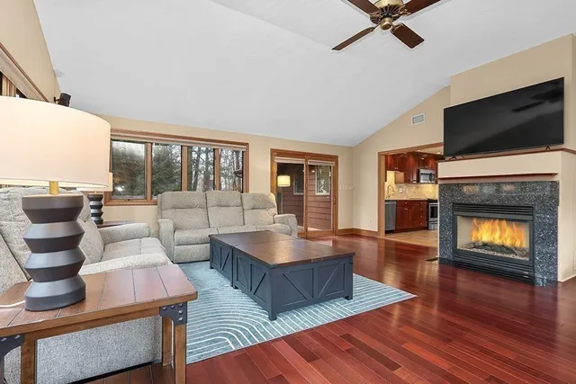 a living room with fireplace furniture and a flat screen tv