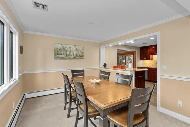 a view of a dining room with furniture and a potted plant