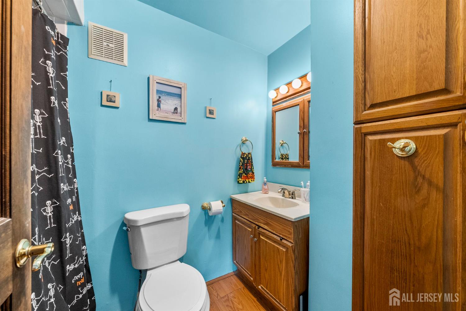202 Ravine Drive Matawan, NJ 07747 - Photo 12 of 41 a bathroom with a toilet a sink and mirror