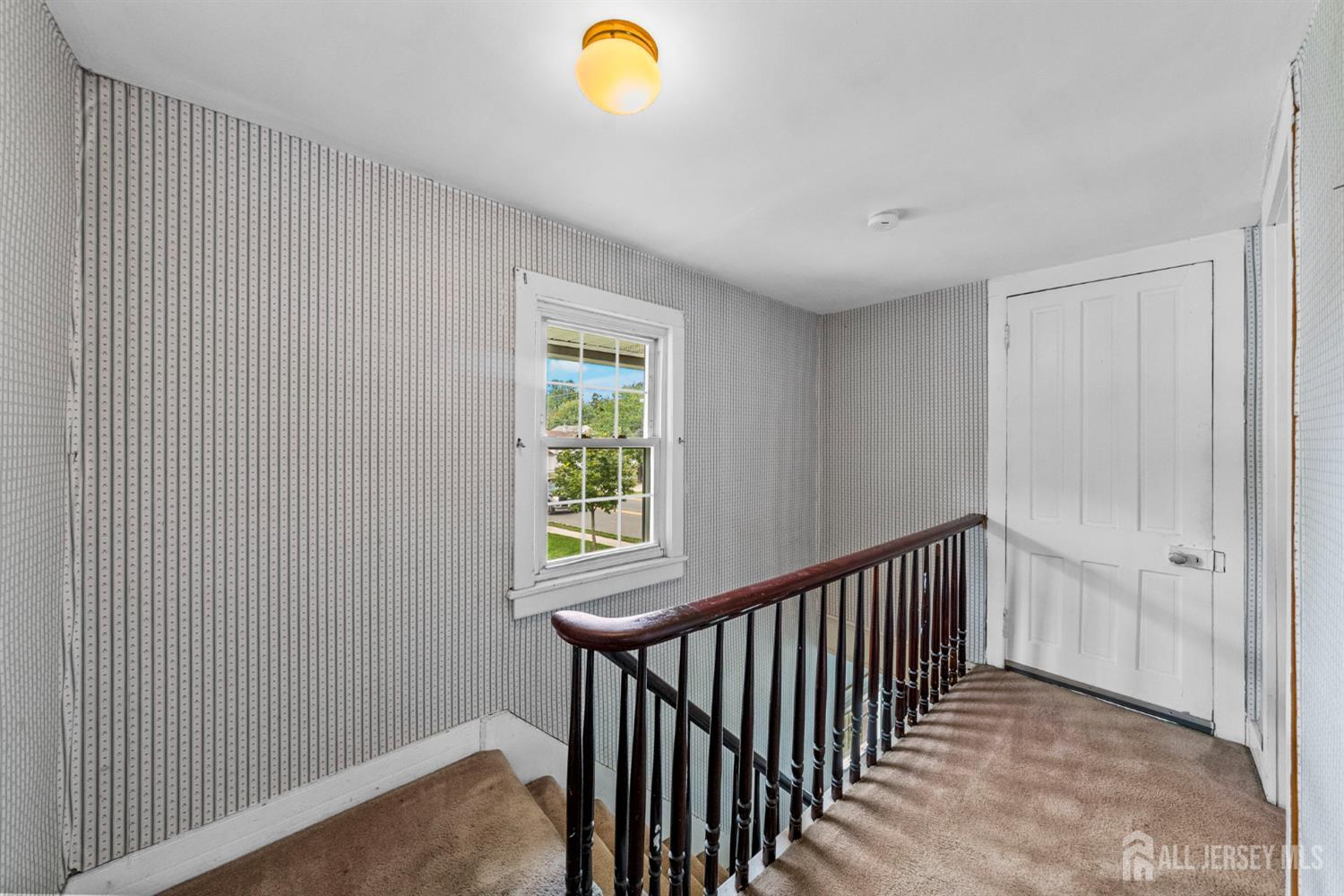 202 Ravine Drive Matawan, NJ 07747 - Photo 17 of 41 a view of a hallway with windows