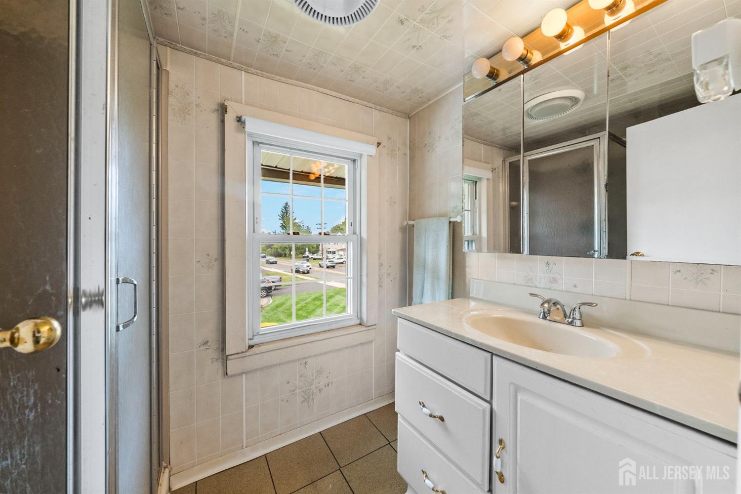 202 Ravine Drive Matawan, NJ 07747 - Photo 19 of 41 a bathroom with a sink and a mirror