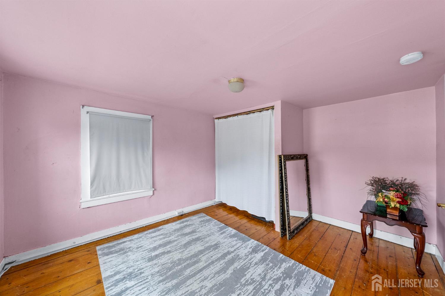 202 Ravine Drive Matawan, NJ 07747 - Photo 20 of 41 a view of a livingroom with wooden floor and a potted plant