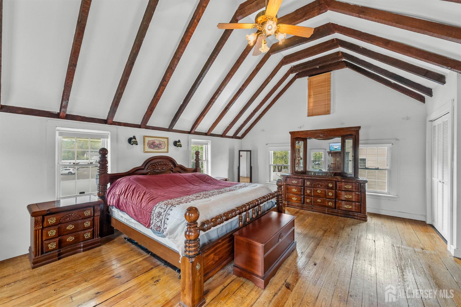 202 Ravine Drive Matawan, NJ 07747 - Photo 25 of 41 a bedroom with a bed and wooden floor