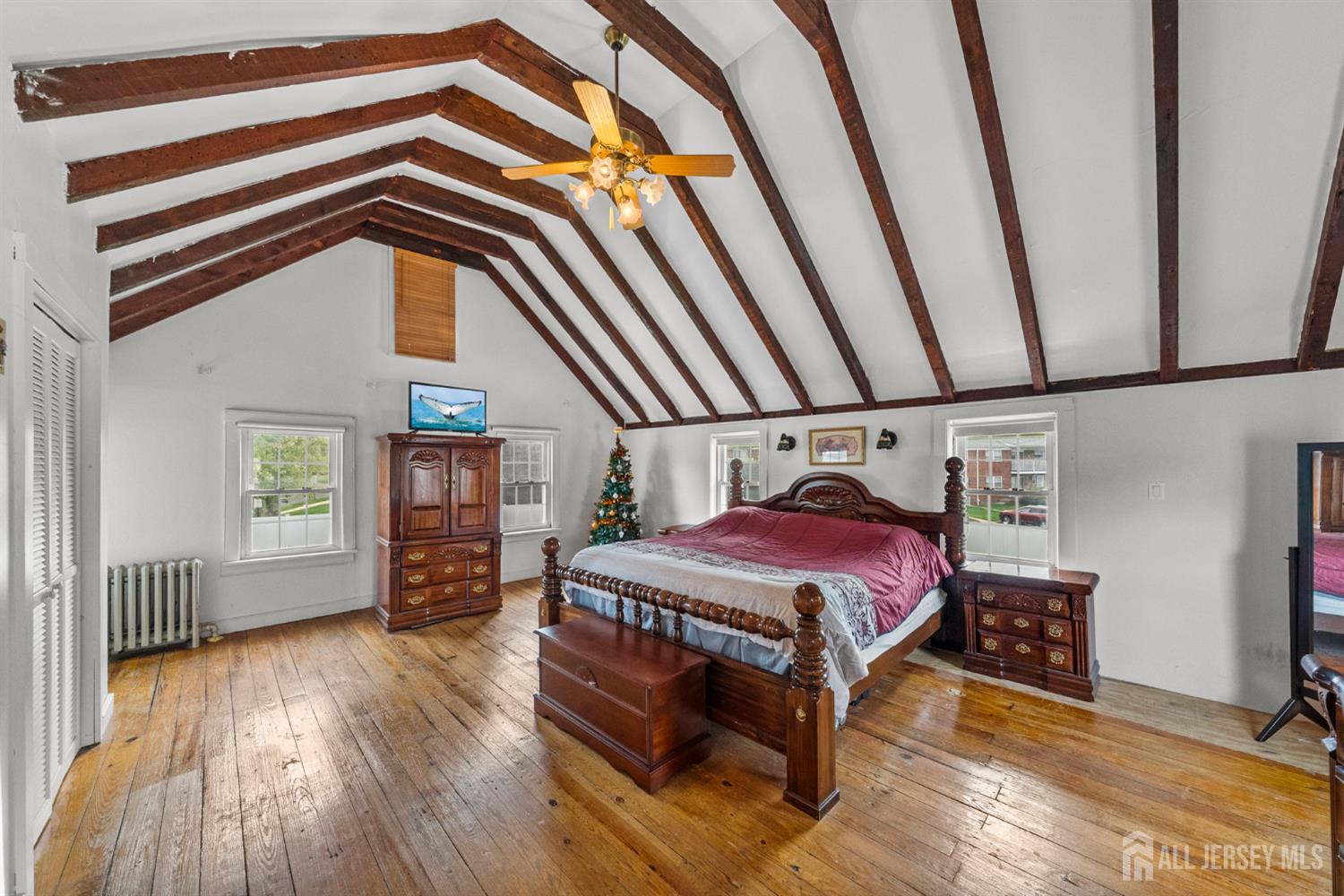 202 Ravine Drive Matawan, NJ 07747 - Photo 26 of 41 a bedroom with a bed and wooden floor