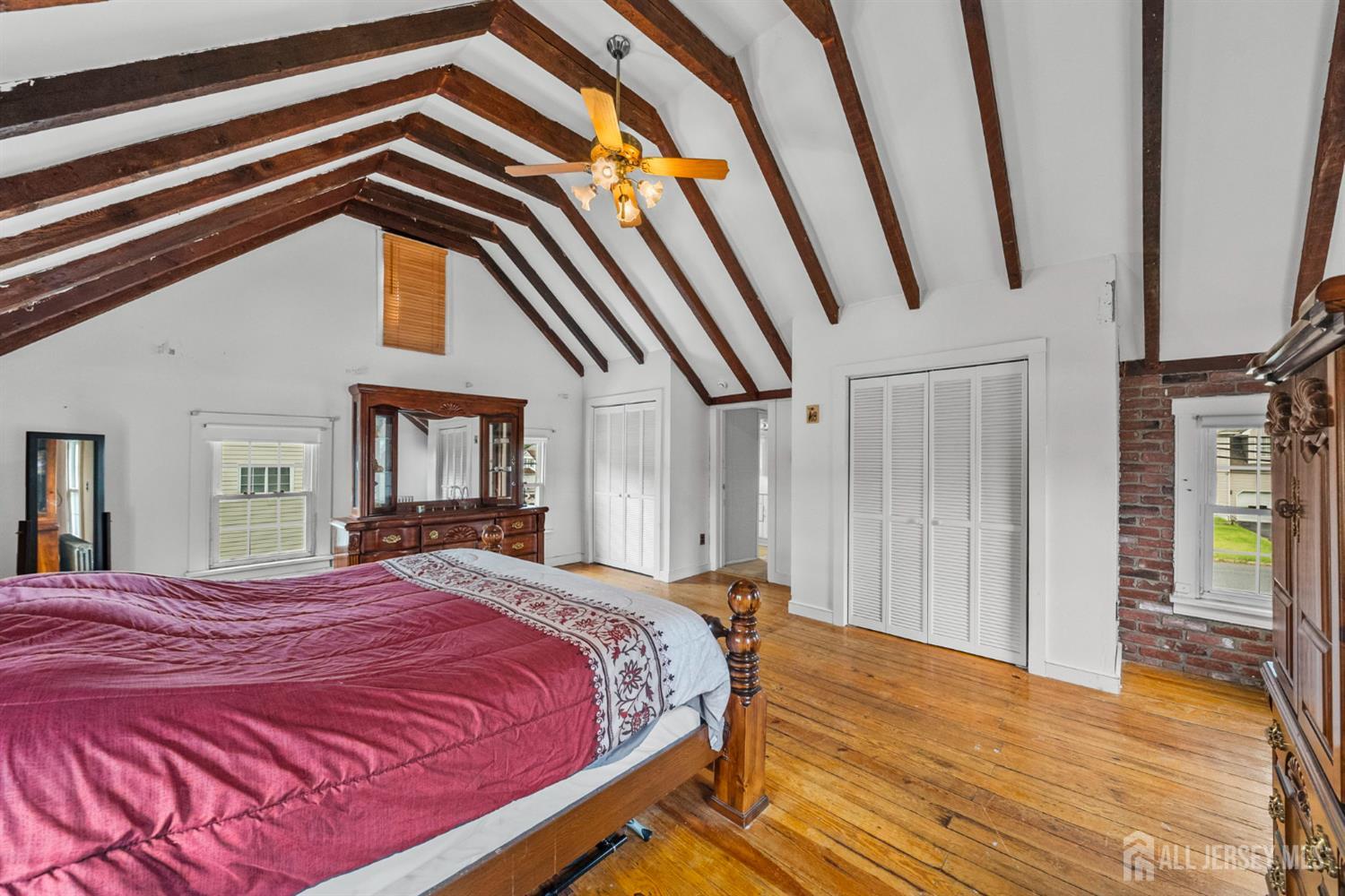 202 Ravine Drive Matawan, NJ 07747 - Photo 27 of 41 a bedroom with a bed and a mirror