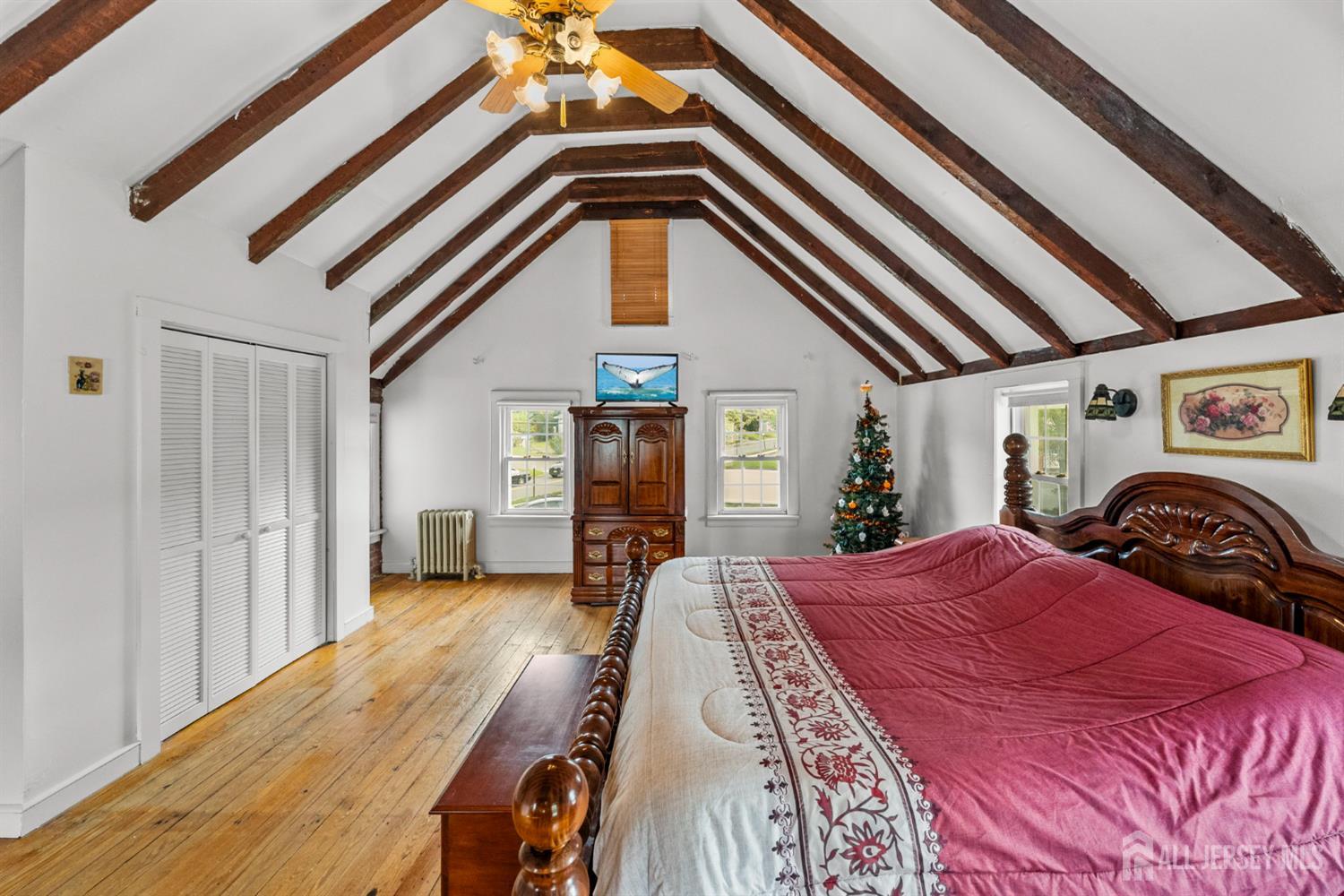 202 Ravine Drive Matawan, NJ 07747 - Photo 28 of 41 a view of a bedroom with a bed and wooden floor
