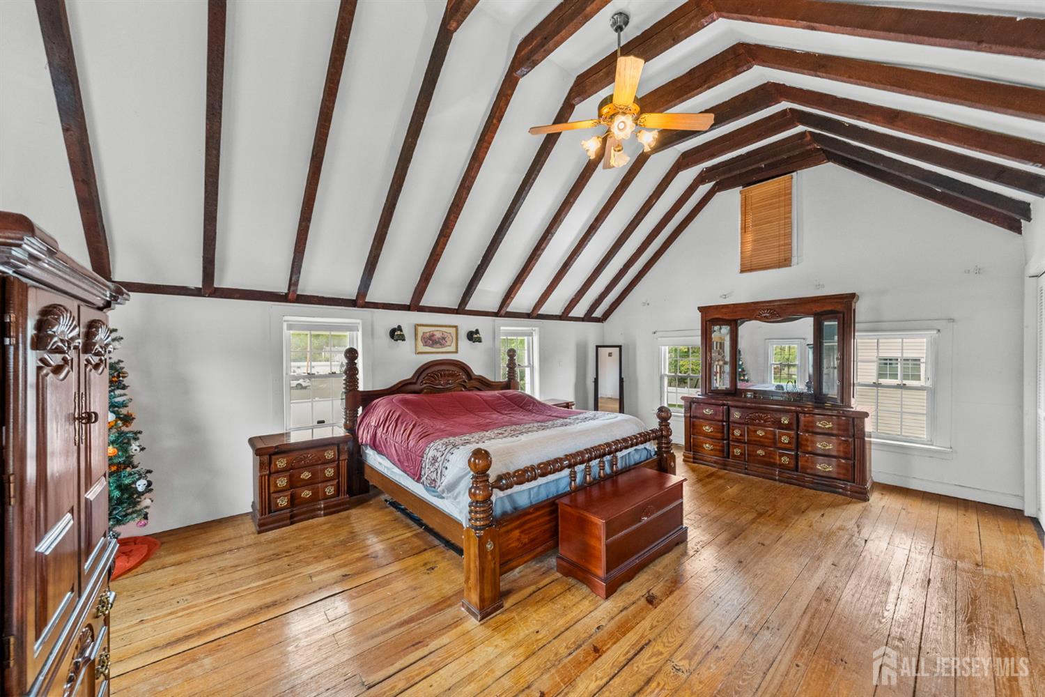 202 Ravine Drive Matawan, NJ 07747 - Photo 4 of 41 a bedroom with a bed and wooden floor