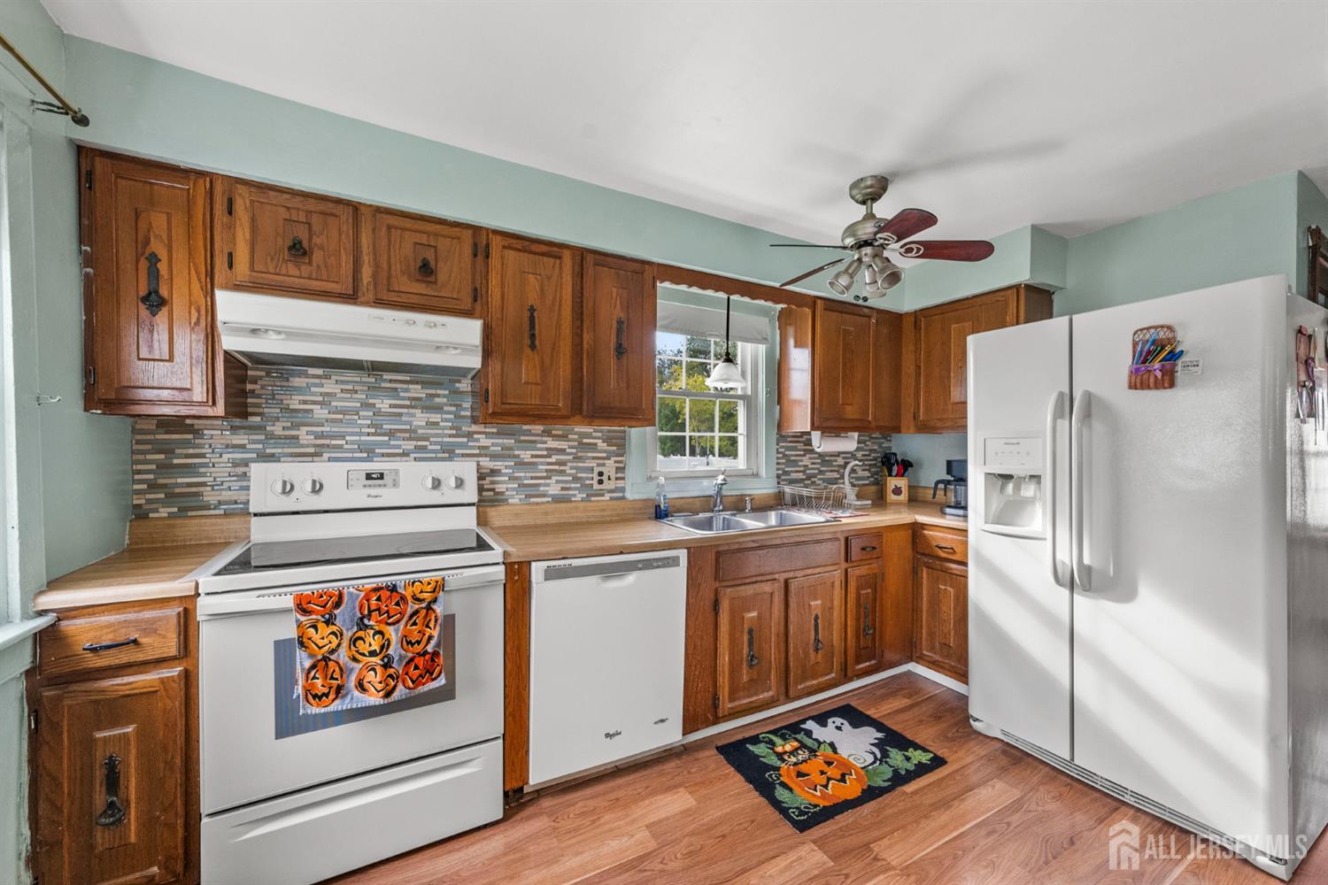 202 Ravine Drive Matawan, NJ 07747 - Photo 7 of 41 a kitchen with stainless steel appliances granite countertop a refrigerator and a stove top oven