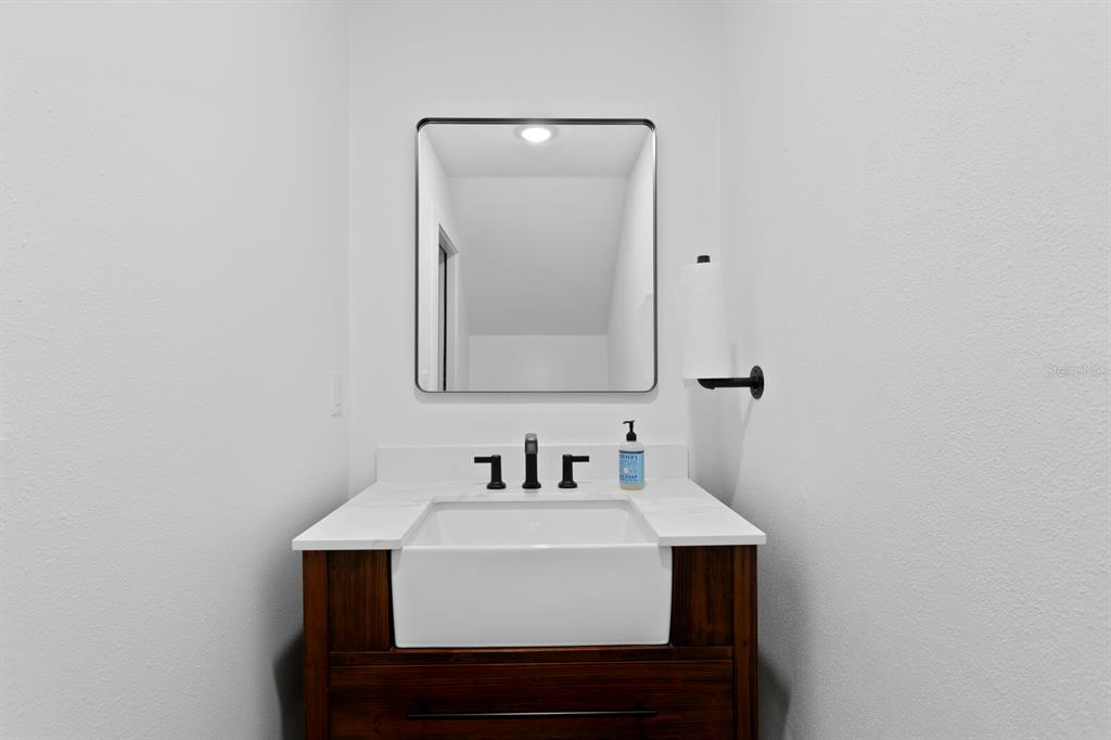 10101 Tarpon Springs Road Odessa, FL 33556 - Photo 17 of 53 a bathroom with a sink and a mirror