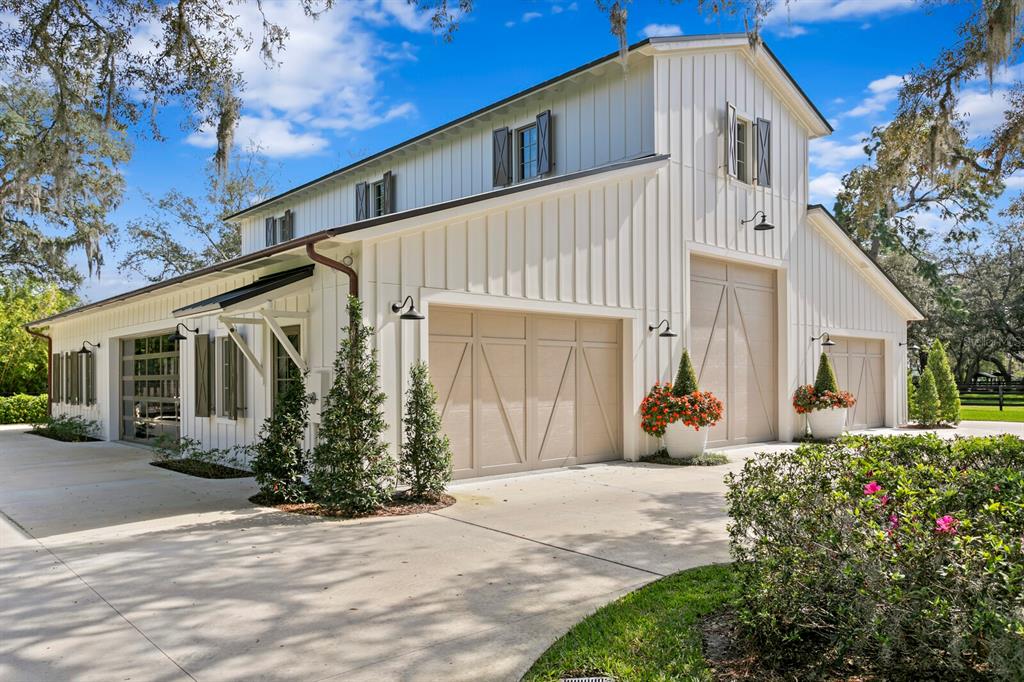 10101 Tarpon Springs Road Odessa, FL 33556 - Photo 18 of 53 a front view of a house with a yard and potted plants