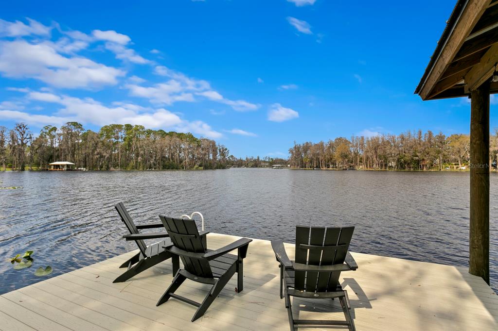 10101 Tarpon Springs Road Odessa, FL 33556 - Photo 3 of 53 a view of a lake with table and chairs