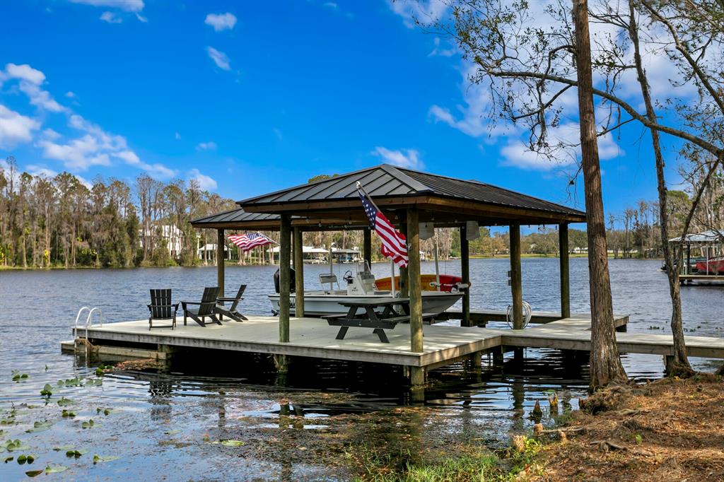 10101 Tarpon Springs Road Odessa, FL 33556 - Photo 33 of 53 a backyard of a house with yard fire pit and outdoor seating