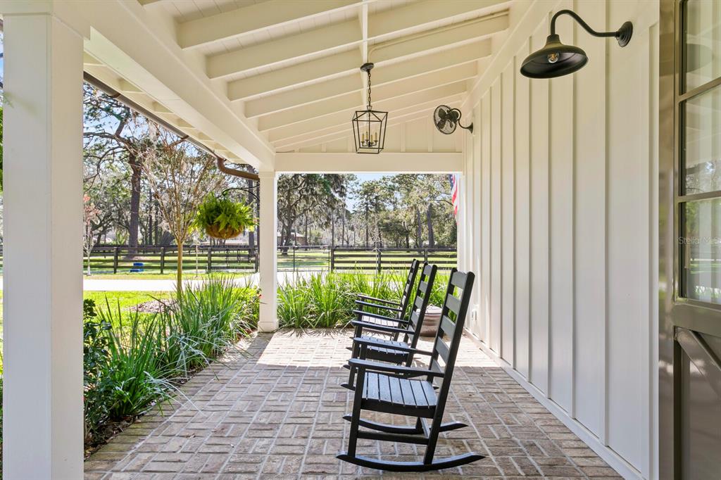 10101 Tarpon Springs Road Odessa, FL 33556 - Photo 7 of 53 a view of a porch with chairs and backyard