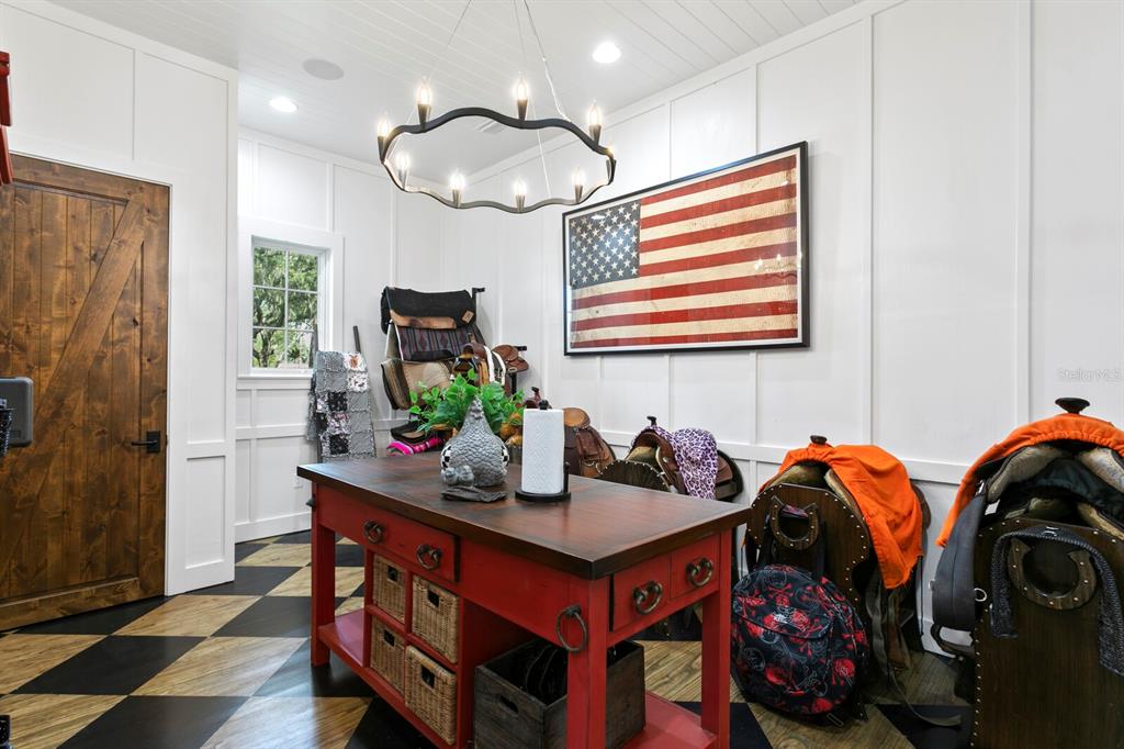 10101 Tarpon Springs Road Odessa, FL 33556 - Photo 10 of 53 a room with furniture a chandelier a mirror and a window