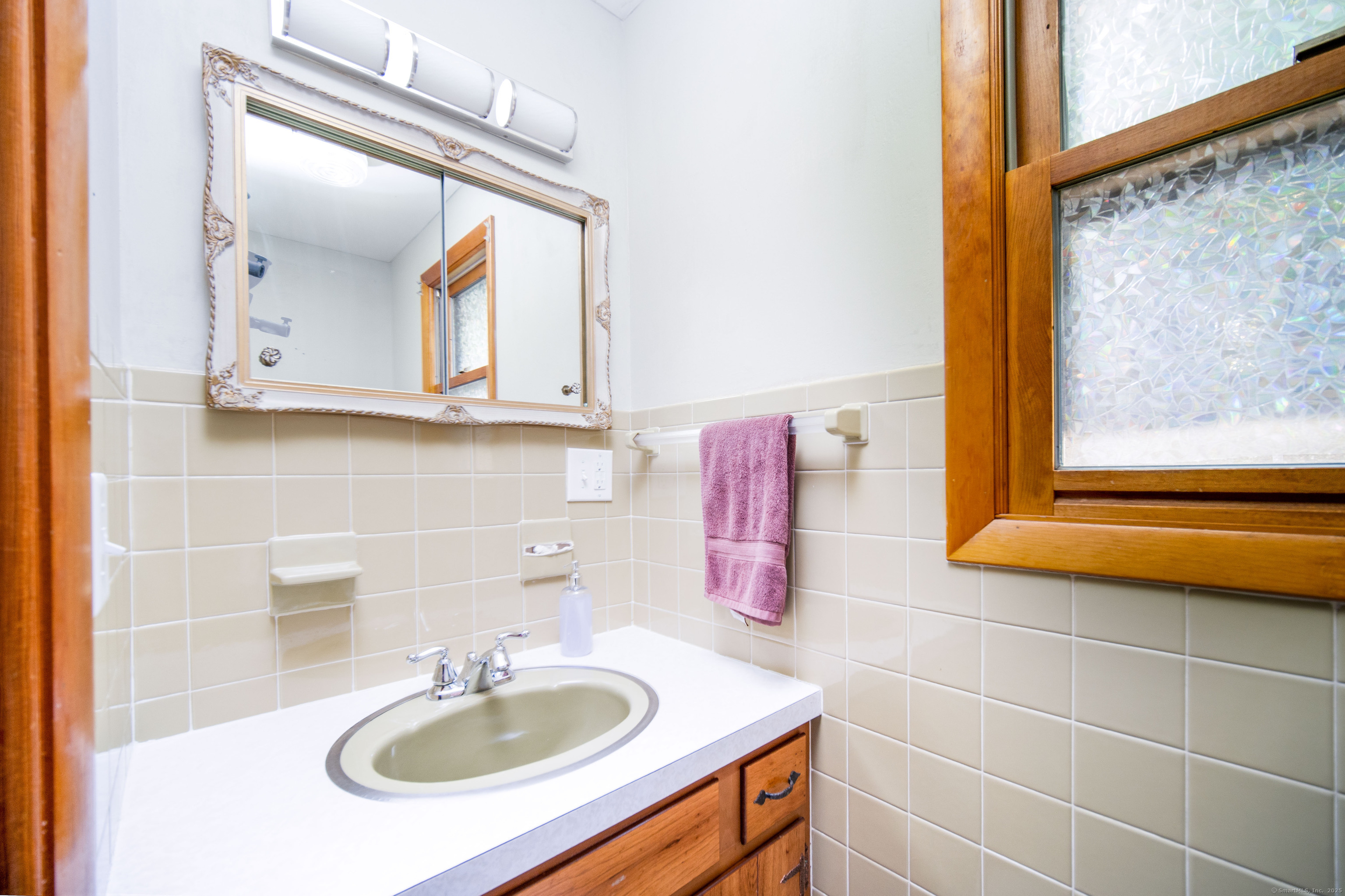 147 Funston Avenue Torrington, CT 06790 - Photo 13 of 40 a bathroom with a sink and a mirror