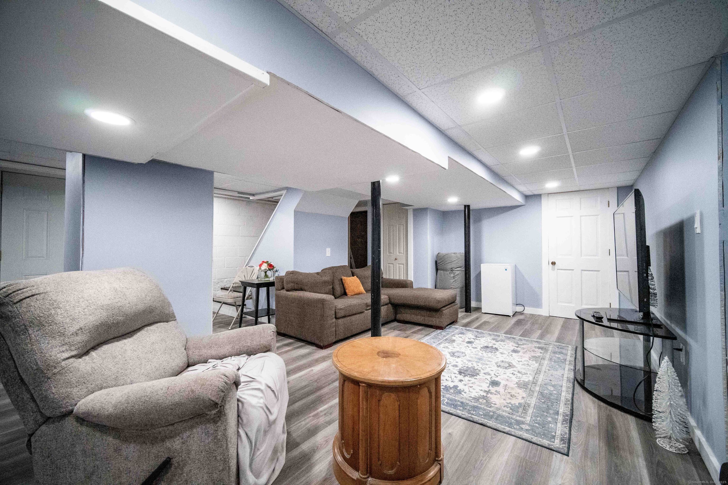 147 Funston Avenue Torrington, CT 06790 - Photo 19 of 40 a living room with furniture and a flat screen tv