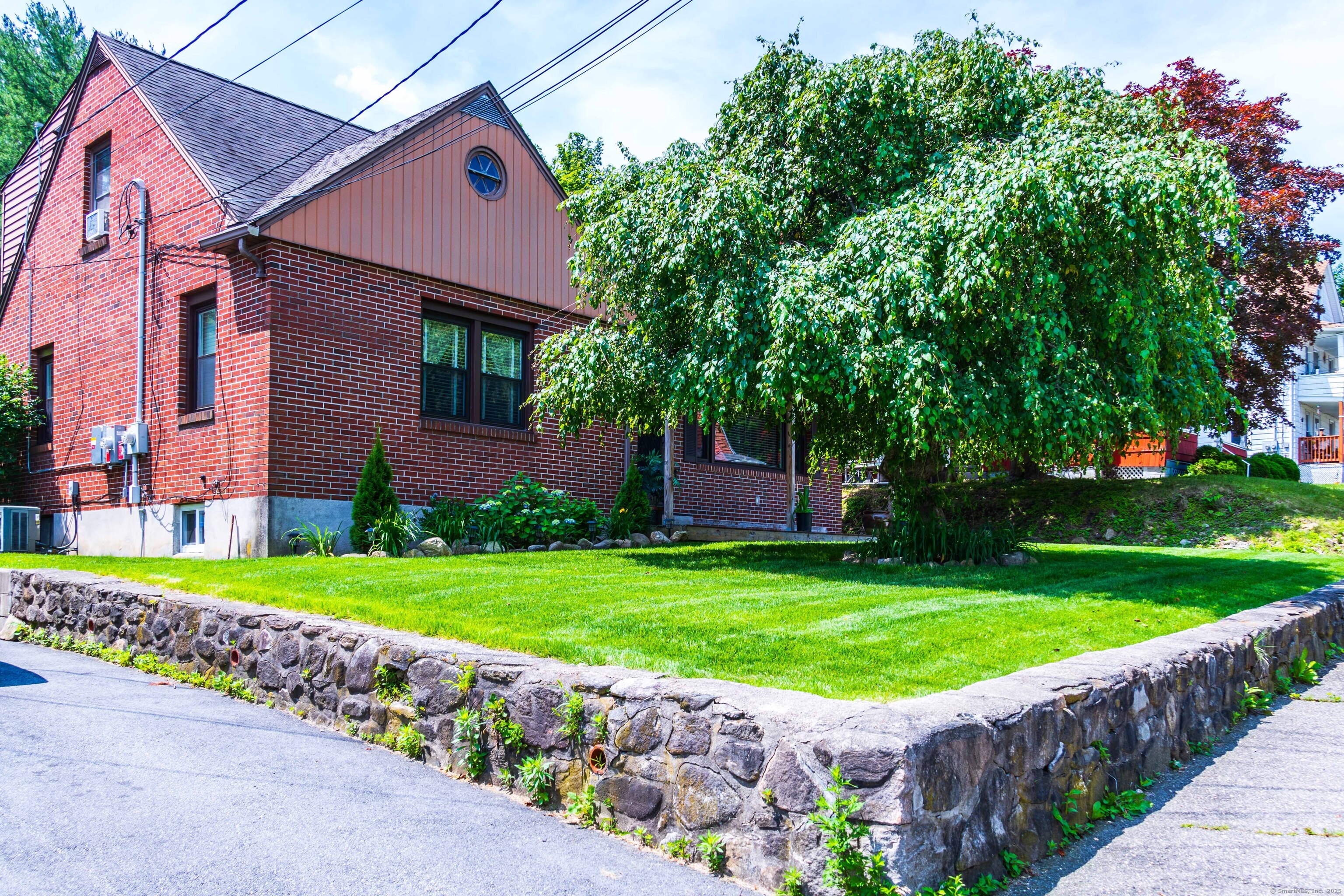 147 Funston Avenue Torrington, CT 06790 - Photo 2 of 40 a view of a garden with a house in the background