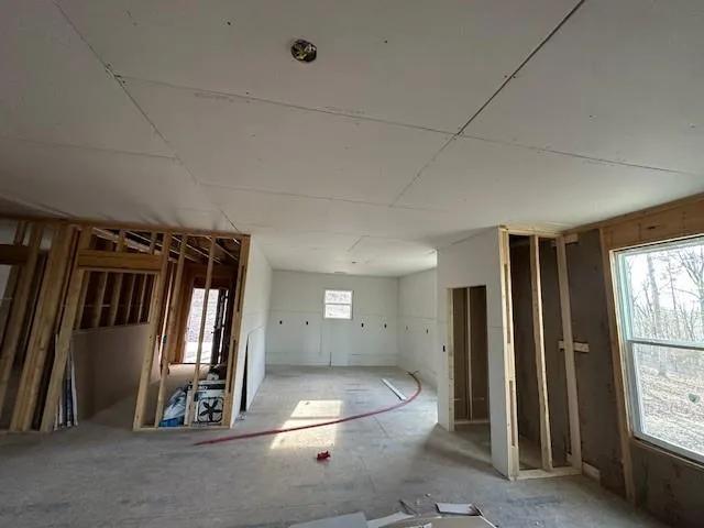 a bed room with a bed and a window