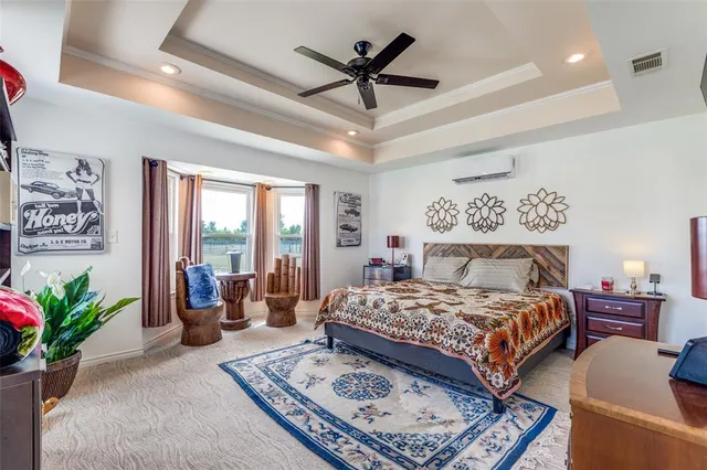 a bedroom with a large bed a potted plant and a large window