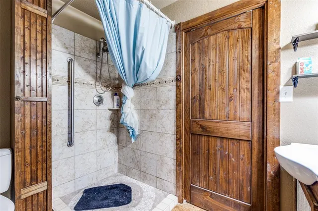 a bathroom with a shower and a sink