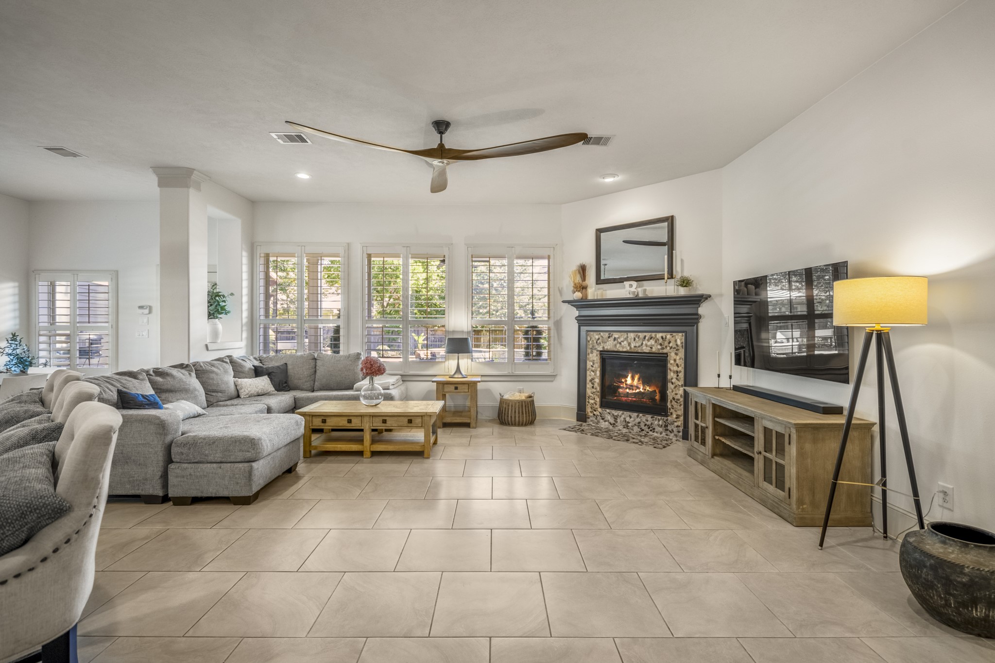 3710 Snowden Point Lane Spring, TX 77386 - Photo 11 of 50 Natural light pours in through multiple windows, highlighting the modern ceiling fan and open layout. Perfect for relaxing and entertaining.