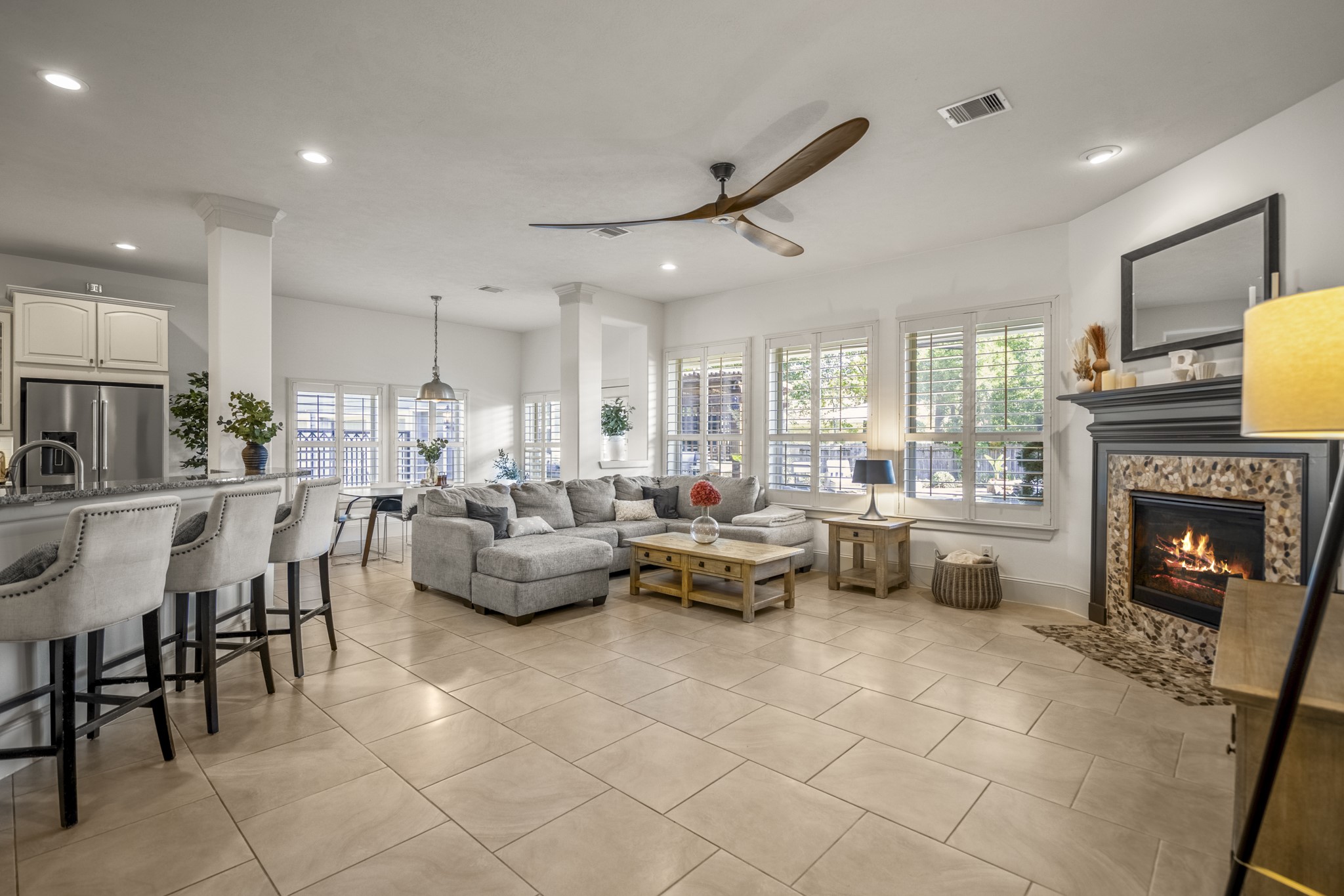 3710 Snowden Point Lane Spring, TX 77386 - Photo 12 of 50 This spacious, open-concept living area features a cozy fireplace, and ample natural light from this wall of windows overlooking your backyard oasis.