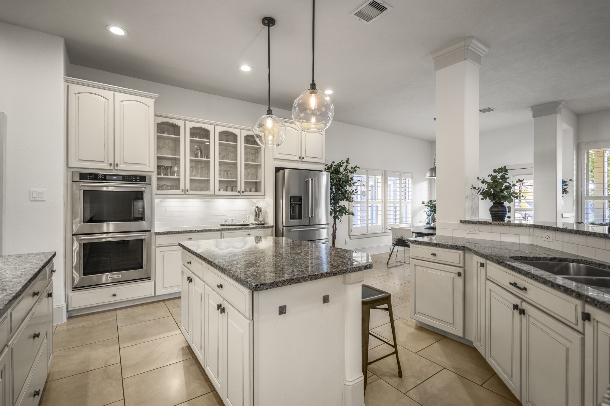 3710 Snowden Point Lane Spring, TX 77386 - Photo 14 of 50 This kitchen features elegant cabinetry, granite countertops, and stainless steel appliances. An island with pendant lighting provides additional workspace. The open layout and large windows create a bright, inviting atmosphere.