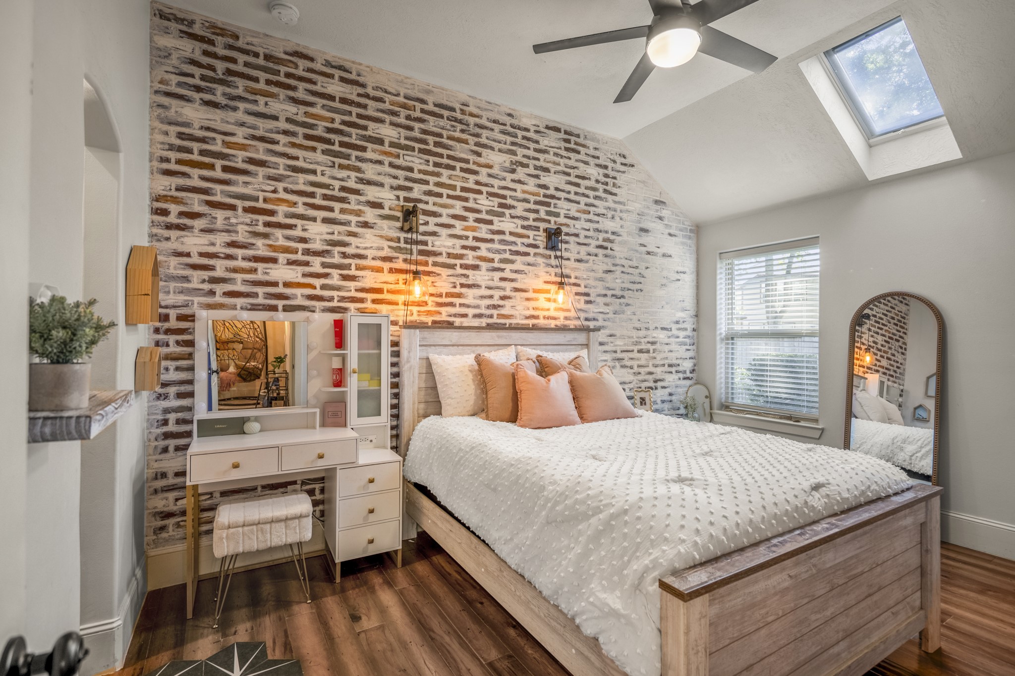3710 Snowden Point Lane Spring, TX 77386 - Photo 25 of 50 1 of 2 secondary bedrooms, featuring an accent wall and brightened by natural light from the skylight and window, also complimented with warm wood flooring.