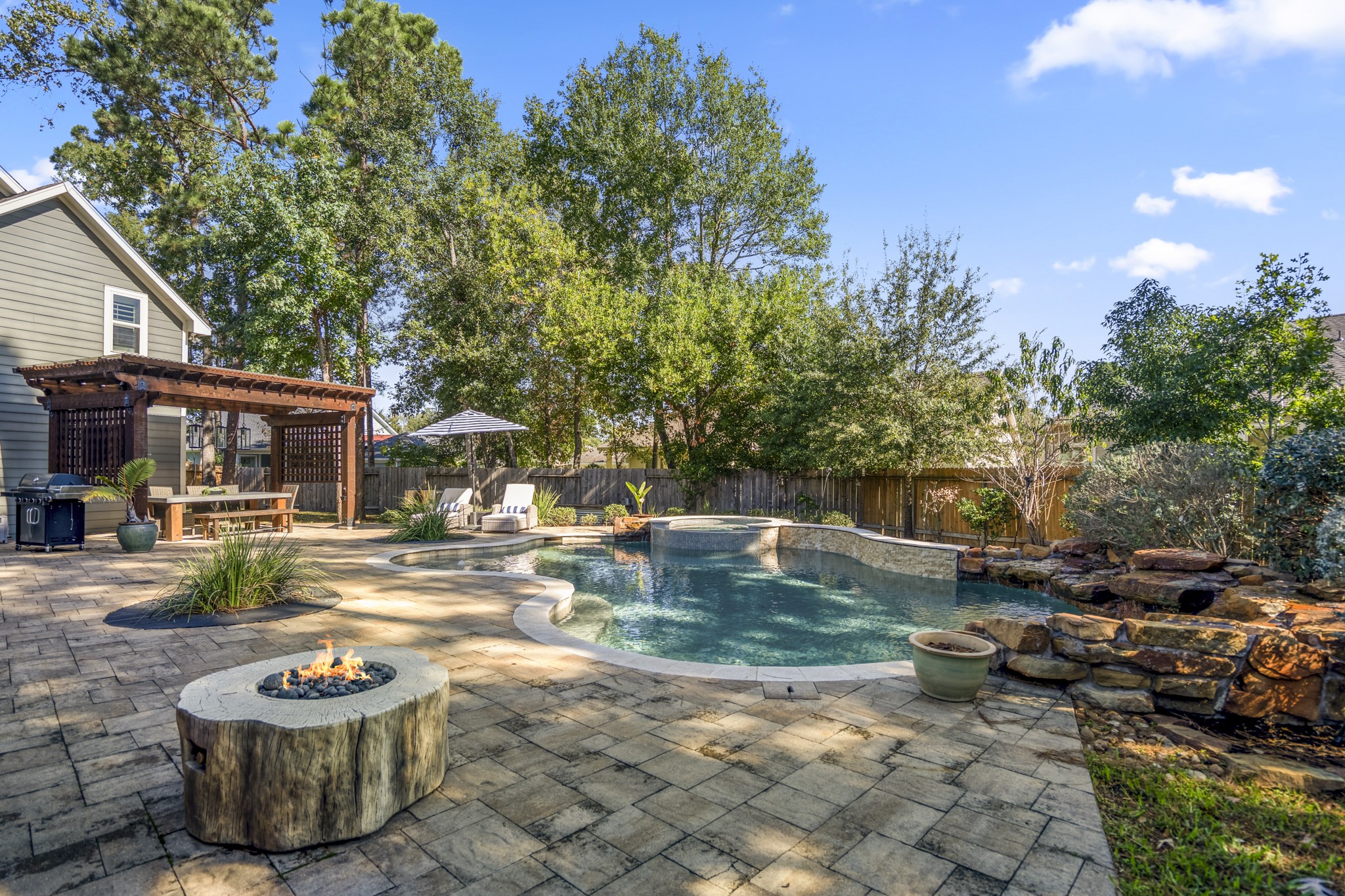 3710 Snowden Point Lane Spring, TX 77386 - Photo 34 of 50 There's a cozy fire pit and a pergola with seating, perfect for outdoor living.