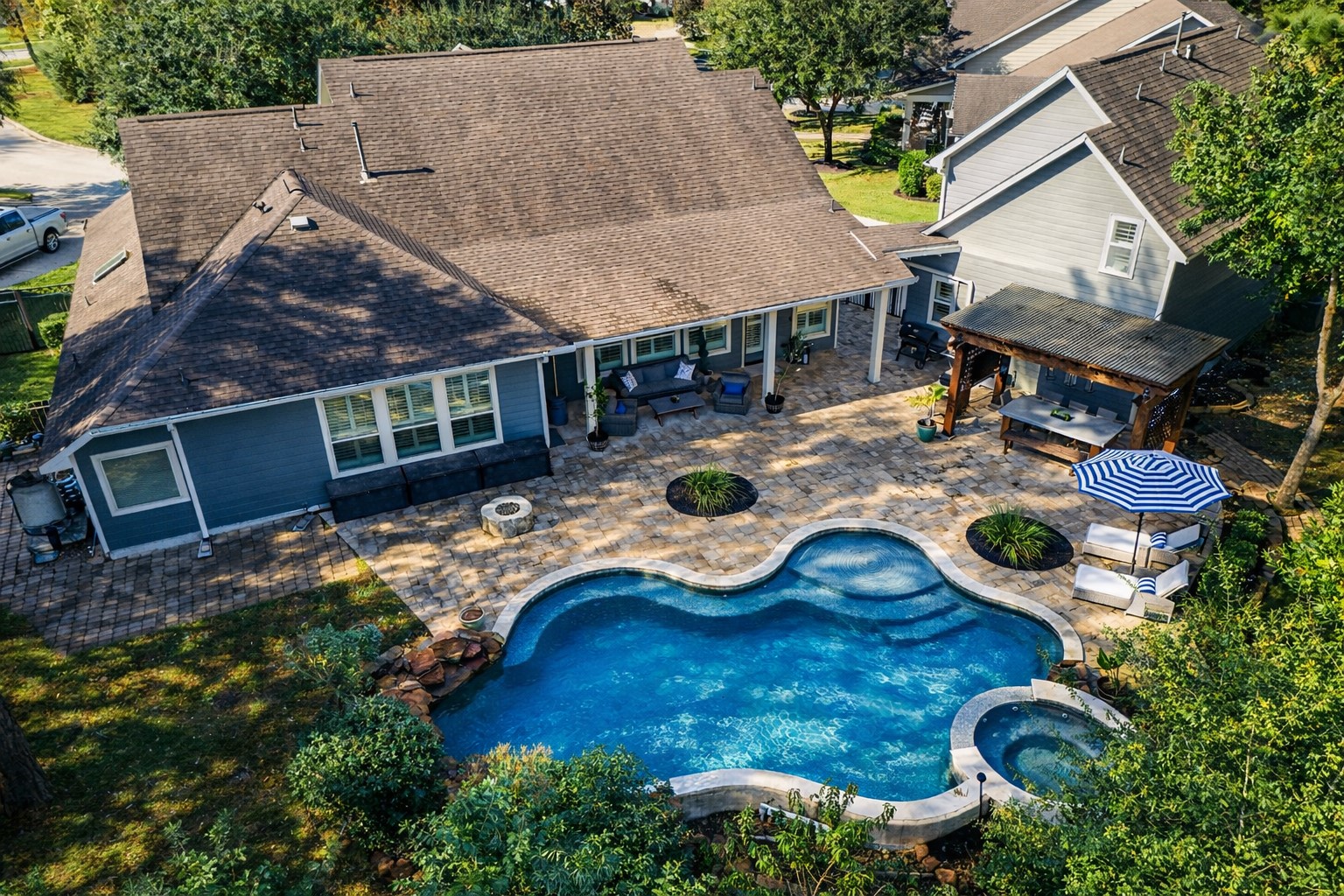 3710 Snowden Point Lane Spring, TX 77386 - Photo 42 of 50 This aerial showcases the spacious backyard with a beautifully designed pool and spa, complemented by a large patio area and green space on both sides.