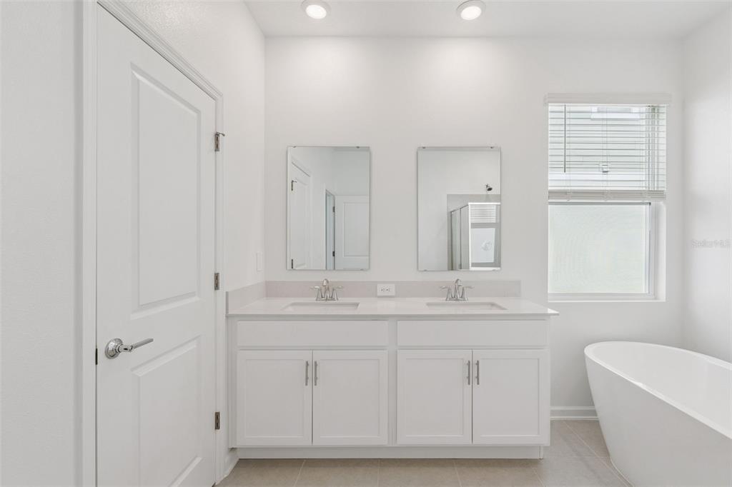1672 Rider Rain Lane Apopka, FL 32703 - Photo 26 of 35 a bathroom with a sink a toilet and a mirror